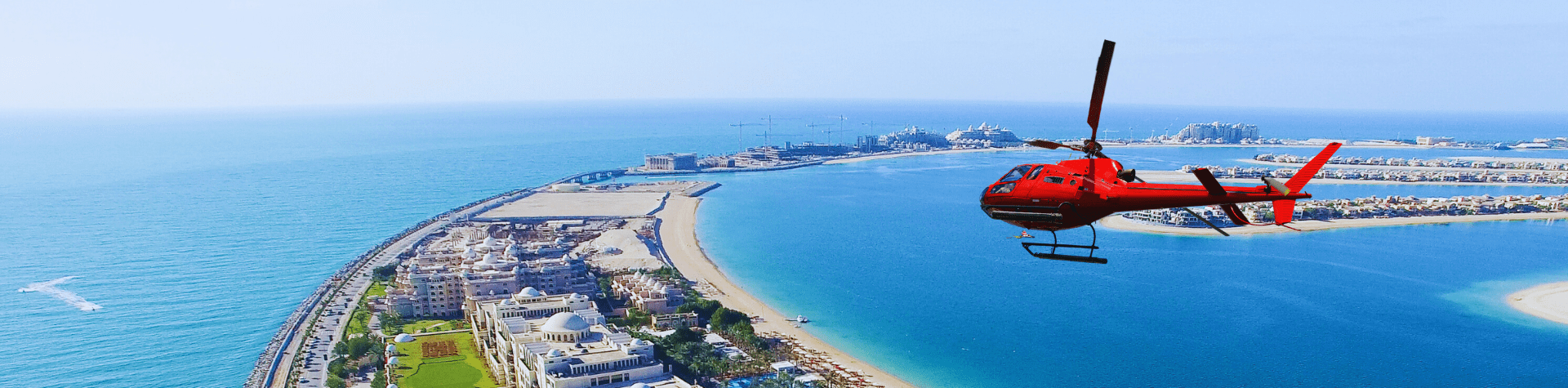 Private helicopter parked on helipad with palm jumairah Dubai in the background, offering luxury helicopter rides and tours.