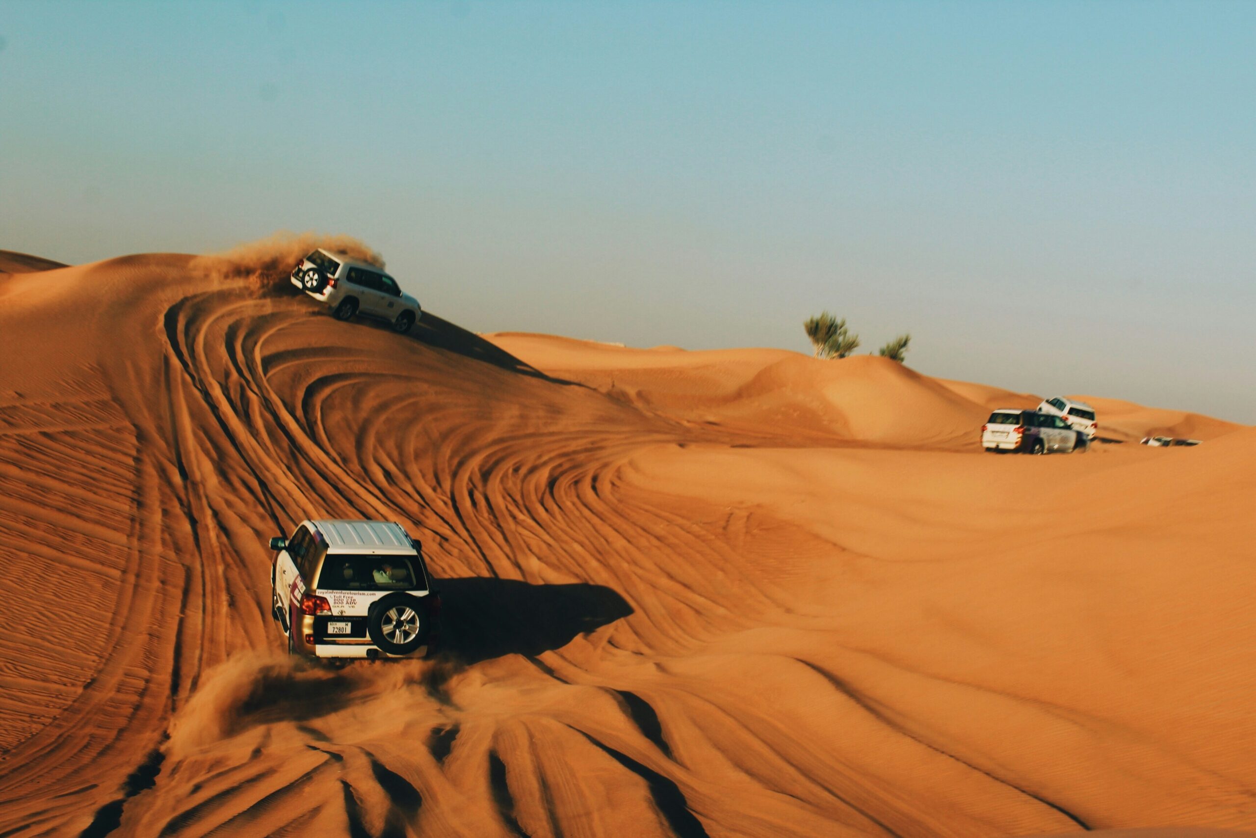 4x4 dune bashing on the red dunes of Dubai desert at sunset