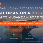 Traditional dhow anchored in the turquoise fjords of Musandam Oman - Dubai to Musandam budget road trip guide 2026 by Mayra Tours