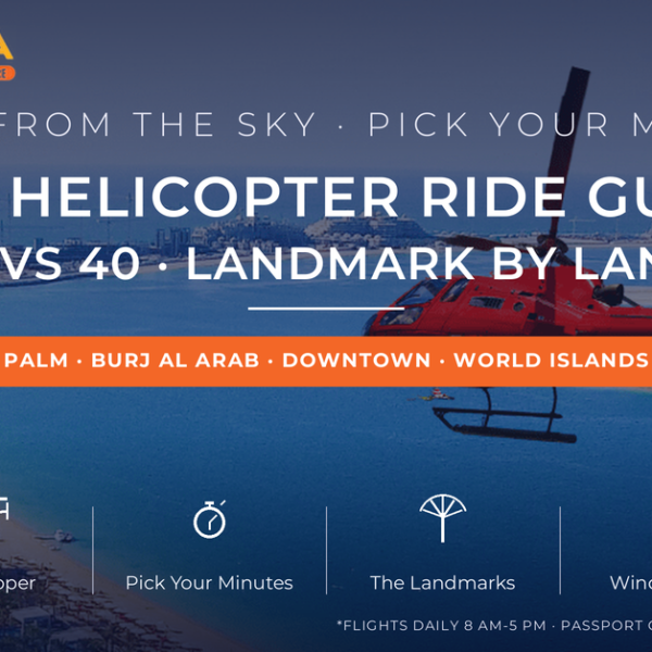 Red helicopter flying over Palm Jumeirah's crescent and turquoise water in Dubai - helicopter ride Dubai guide comparing 12, 22 and 40 minute flights landmark by landmark by Mayra Tours