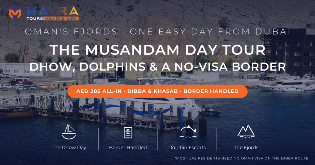 Khasab harbour in Musandam Oman with a catamaran ferry docked beneath sheer Hajar mountain cliffs - Musandam tour from Dubai day-trip guide with dhow cruise and border pass by Mayra Tours