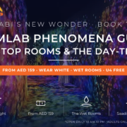 Visitor in white dress walking through a glowing corridor of projected flowers at teamLab Phenomena Abu Dhabi on Saadiyat Island - complete guide with tickets, what to wear and day trip from Dubai by Mayra Tours